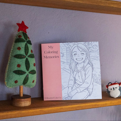 Kindred Color co custom Coloring book, a felt tree, and small bear toy on a shelf.